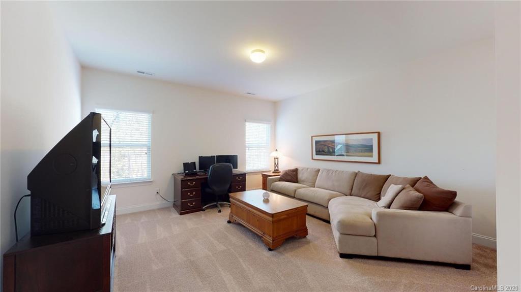 6018 Fallondale Road Waxhaw, NC 28173 - Photo 29 of 48 a living room with furniture and a flat screen tv