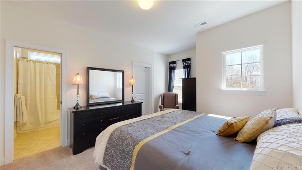 6018 Fallondale Road Waxhaw, NC 28173 - Photo 31 of 48 a bedroom with a bed and wooden floor