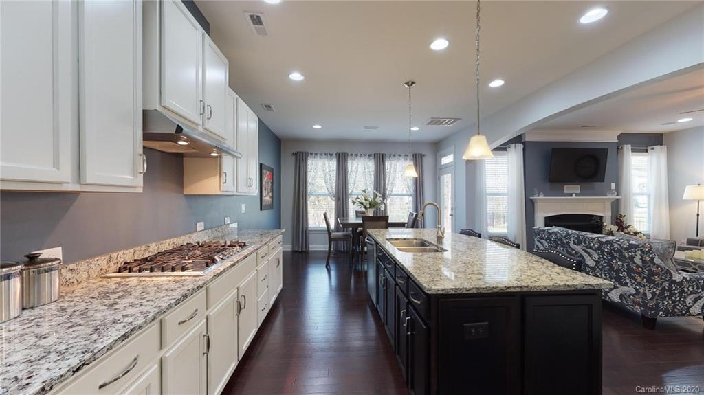 6018 Fallondale Road Waxhaw, NC 28173 - Photo 8 of 48 a large kitchen with stainless steel appliances granite countertop a lot of counter space and wooden floor