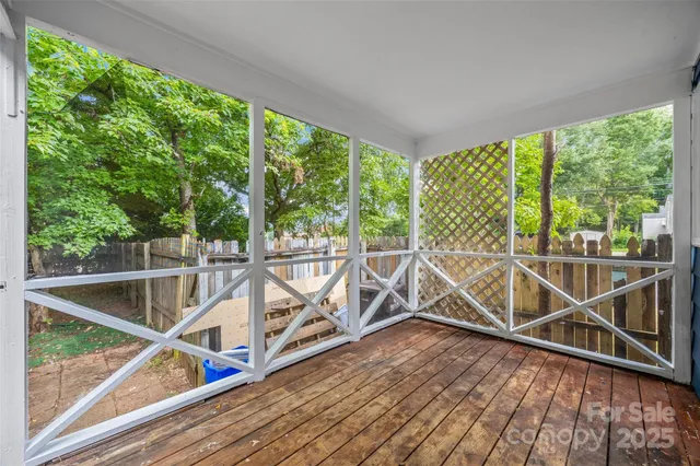 a view of a balcony with wooden floor and wooden fence