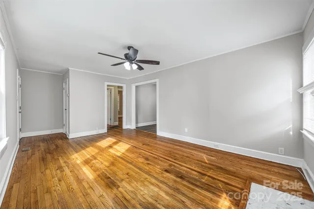 a view of room with wooden floor and ceiling fan