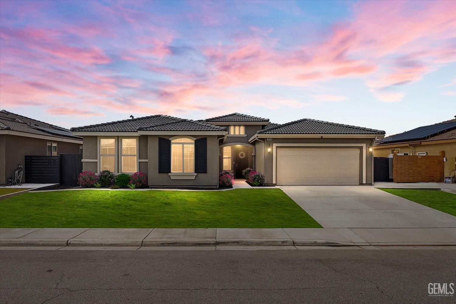 a view of a yard in front of a house with garage