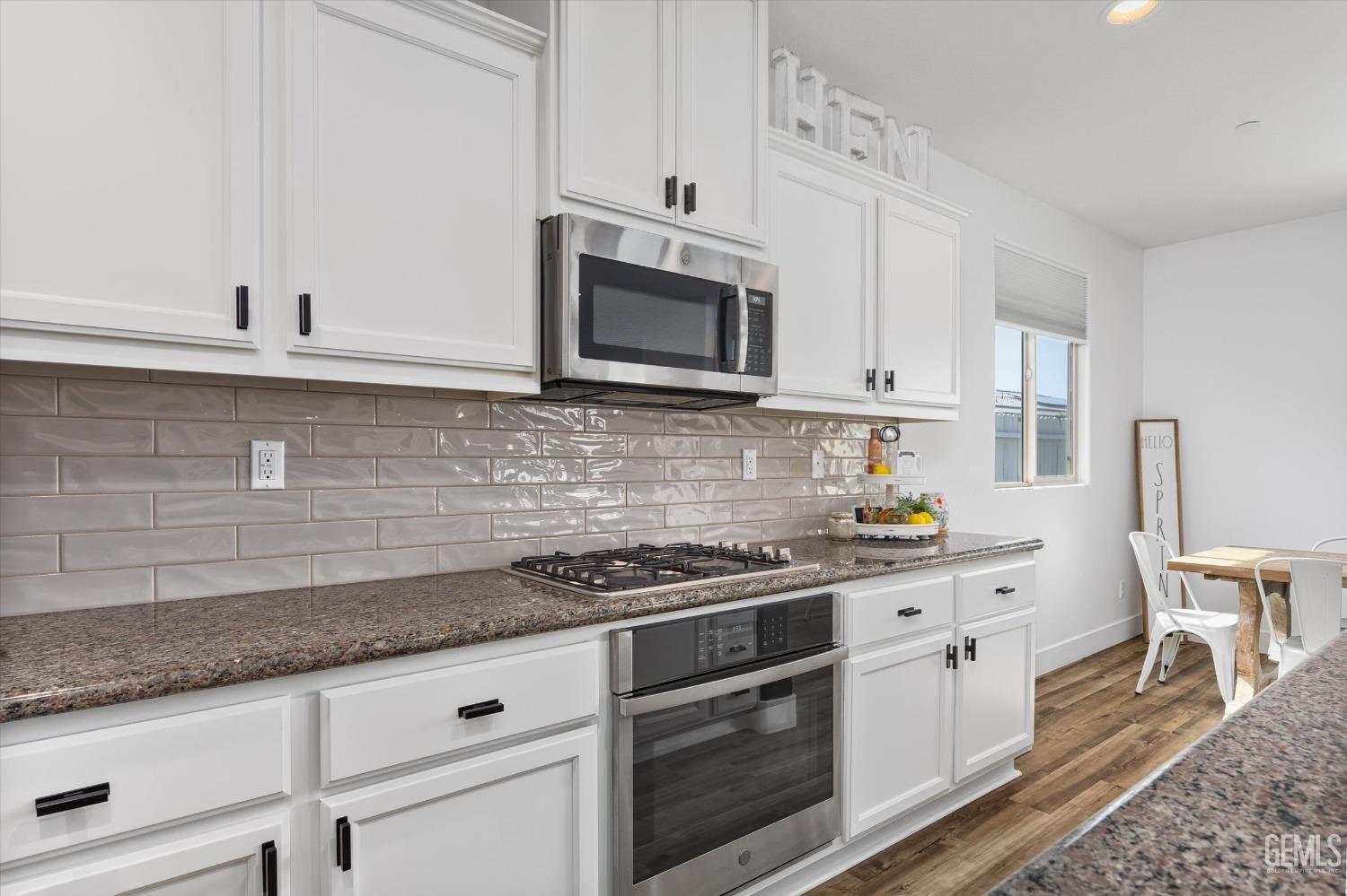 Undisclosed Address Bakersfield, CA 93314 - Photo 13 of 43 a kitchen with granite countertop cabinets stainless steel appliances and a sink