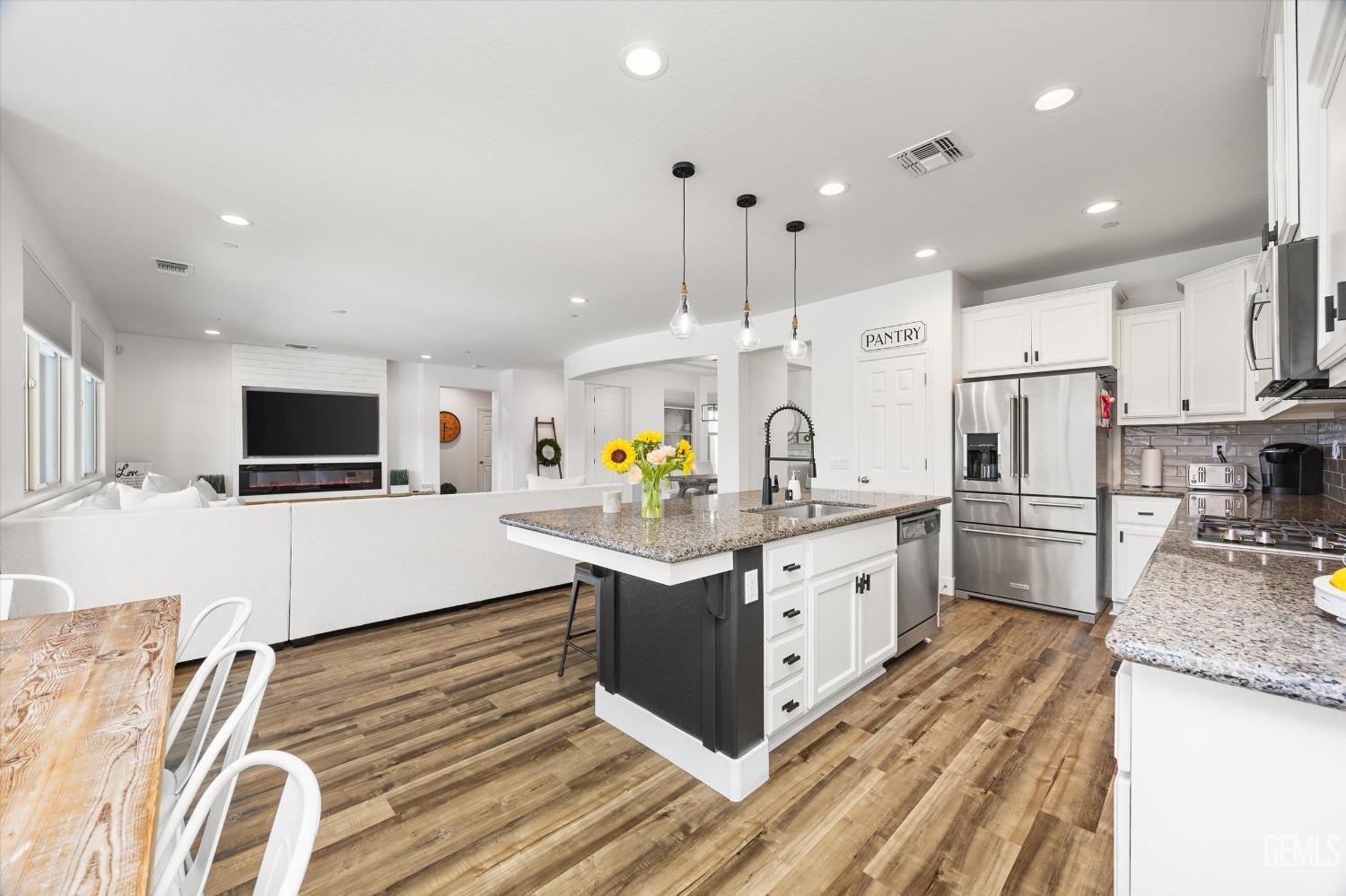 Undisclosed Address Bakersfield, CA 93314 - Photo 14 of 43 a kitchen with stainless steel appliances granite countertop a sink stove and refrigerator