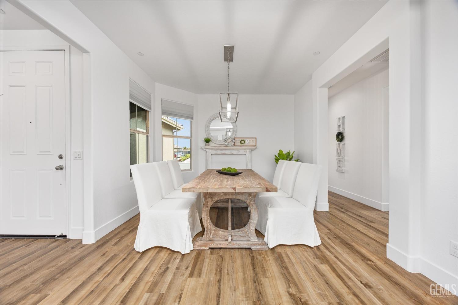 Undisclosed Address Bakersfield, CA 93314 - Photo 21 of 43 a view of a dining room with furniture wooden floor and chandelier