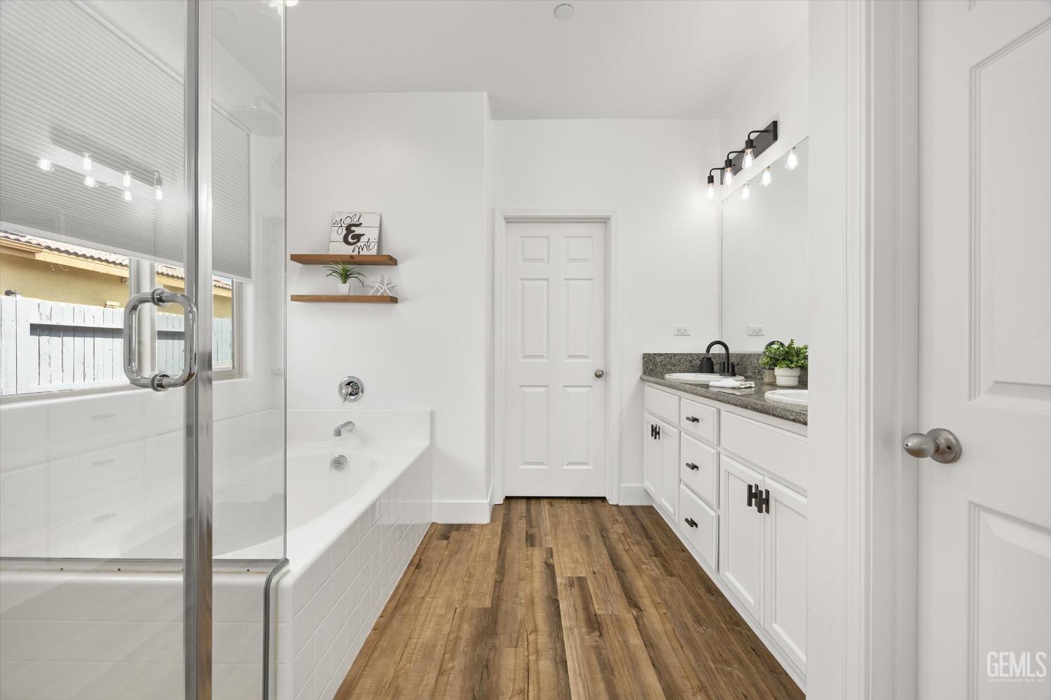 Undisclosed Address Bakersfield, CA 93314 - Photo 26 of 43 a bathroom with a bathtub and shower