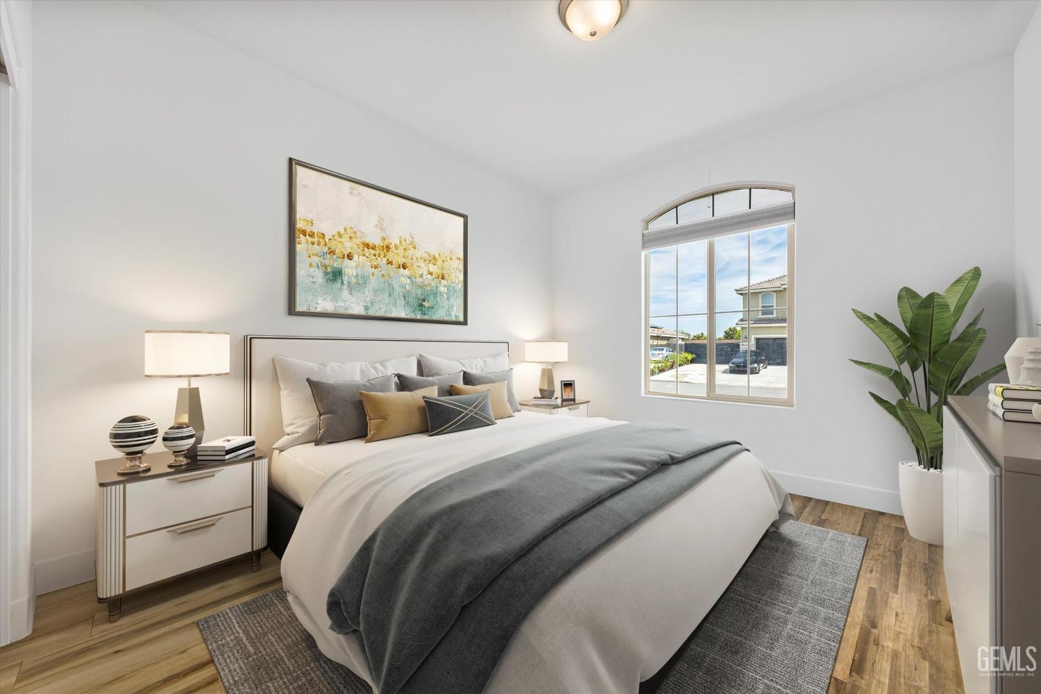 Undisclosed Address Bakersfield, CA 93314 - Photo 30 of 43 a bedroom with bed and a potted plant