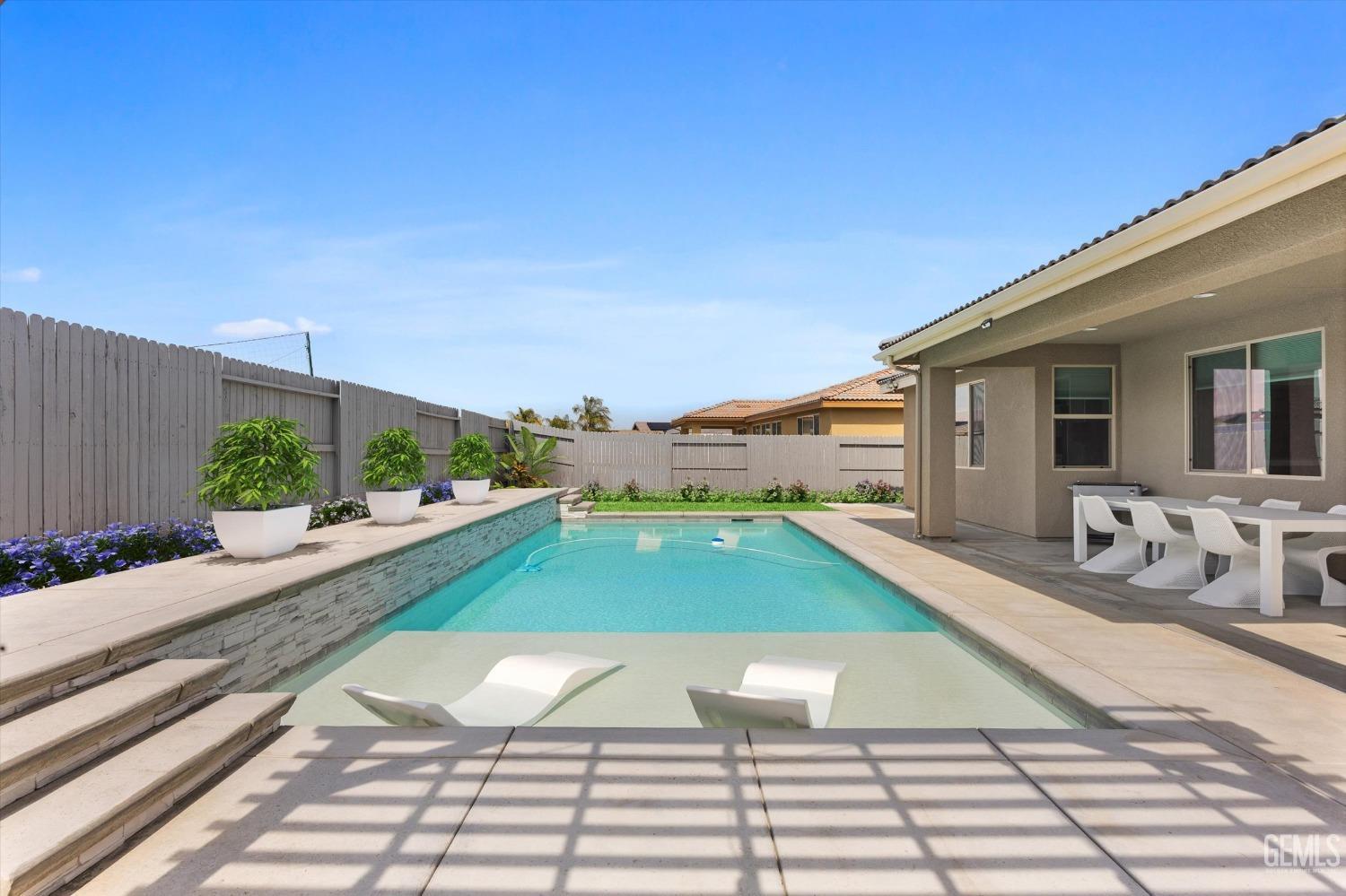 Undisclosed Address Bakersfield, CA 93314 - Photo 37 of 43 a view of a swimming pool with a lounge chairs