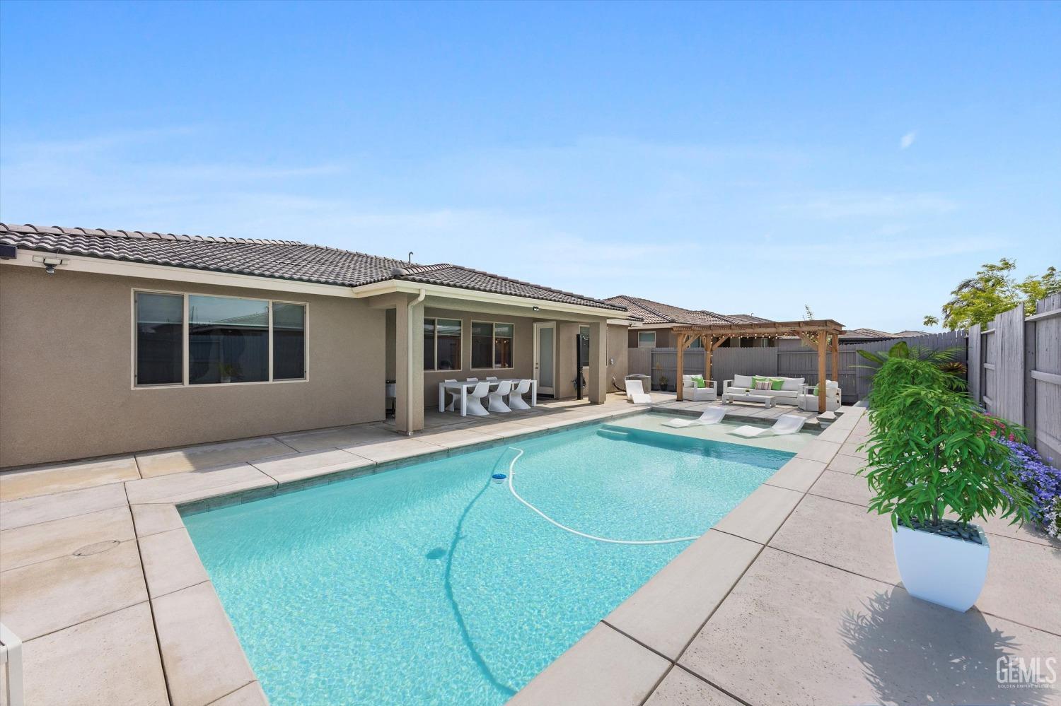 Undisclosed Address Bakersfield, CA 93314 - Photo 40 of 43 a view of a house with backyard swimming pool and sitting area