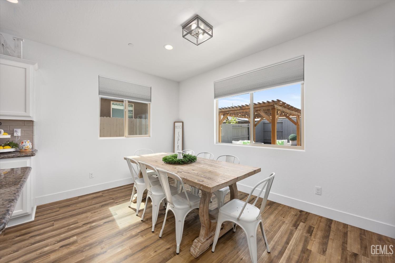 Undisclosed Address Bakersfield, CA 93314 - Photo 10 of 43 a view of a dining room with furniture and wooden floor