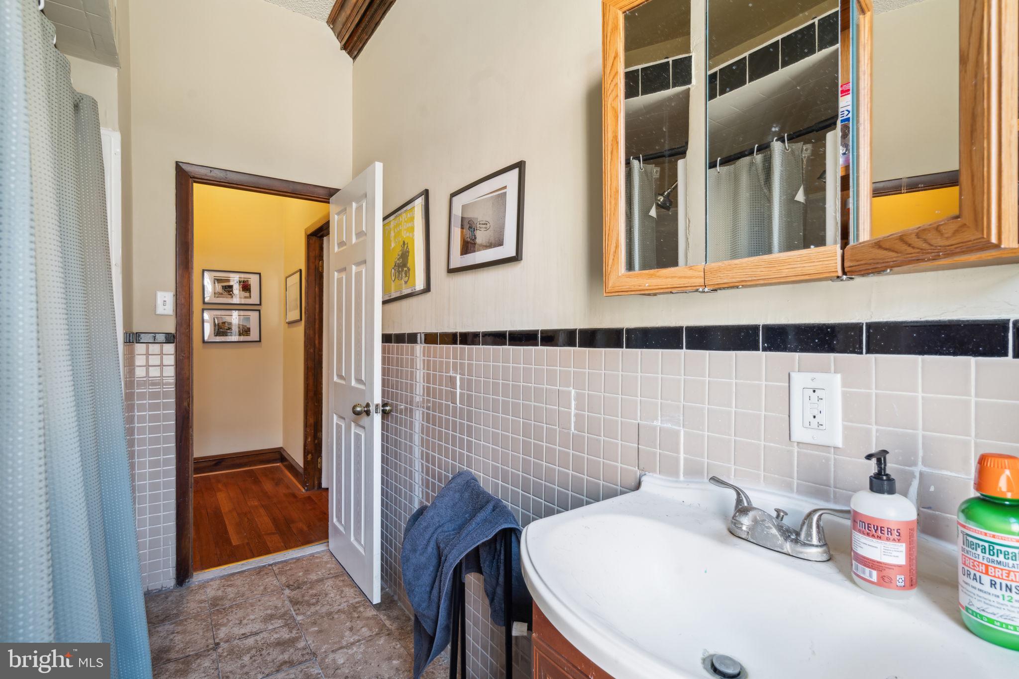 4036 Spring Garden Street Philadelphia, PA 19104 - Photo 12 of 46 a bathroom with a sink and a mirror