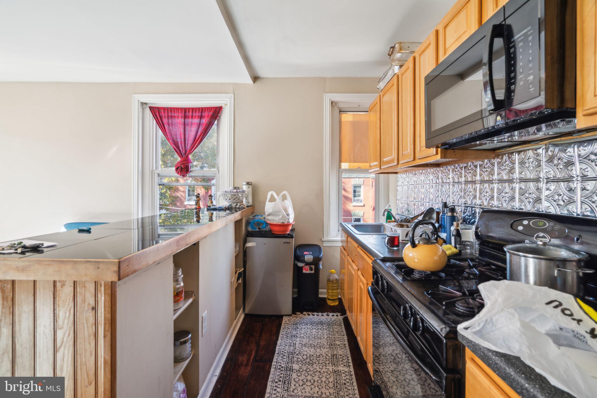 4036 Spring Garden Street Philadelphia, PA 19104 - Photo 14 of 46 a utility room with stainless steel appliances granite countertop a stove and a refrigerator