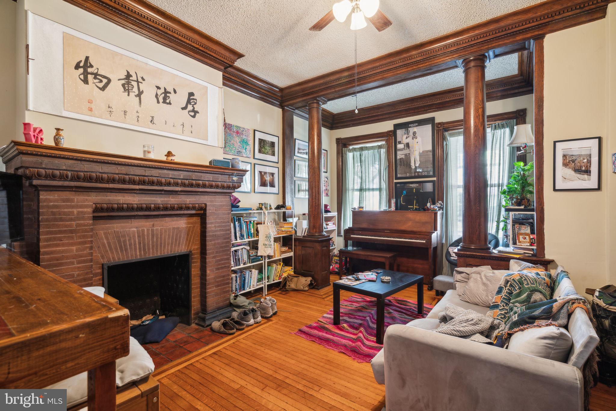 4036 Spring Garden Street Philadelphia, PA 19104 - Photo 2 of 46 a living room with furniture a fireplace and a window