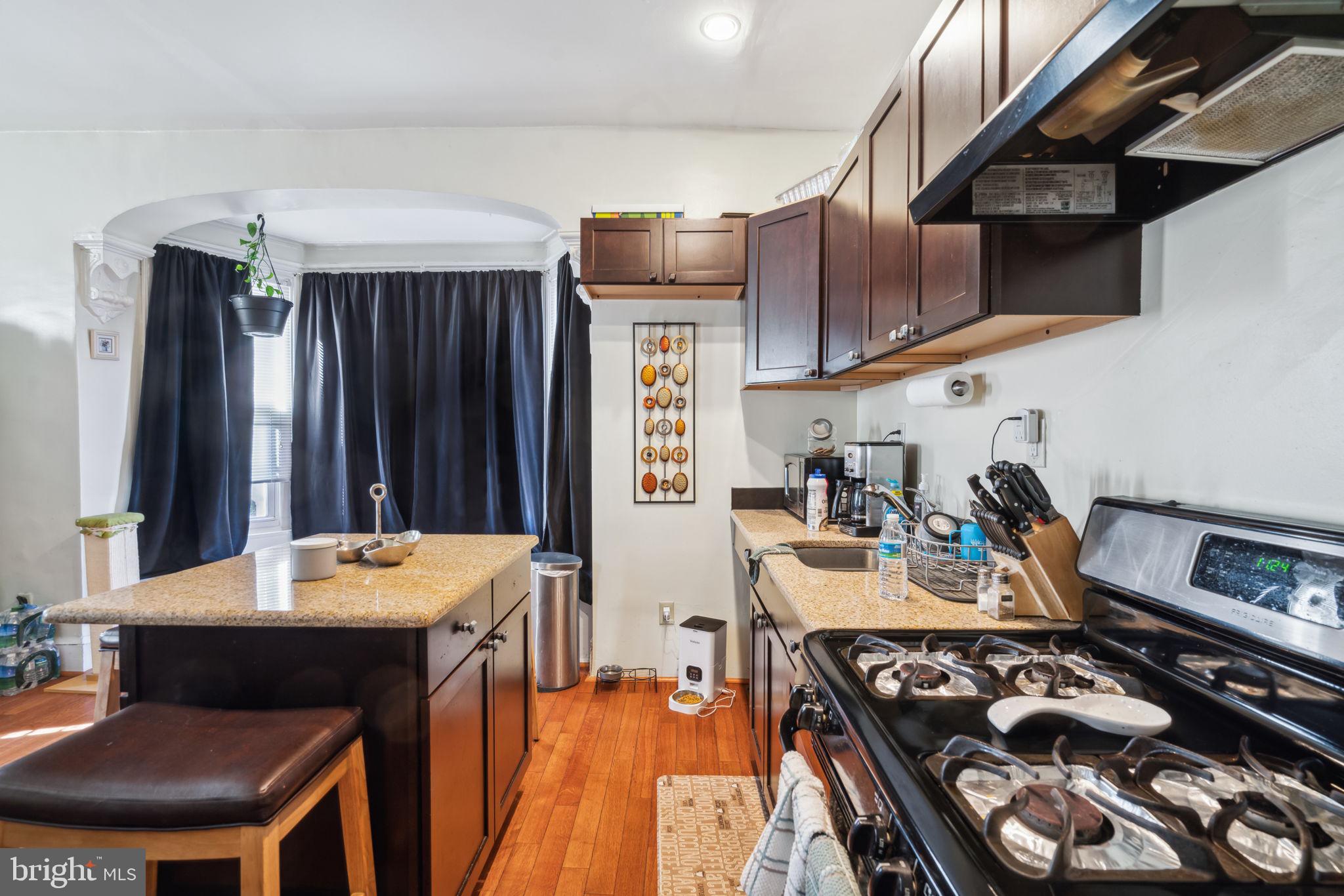 4036 Spring Garden Street Philadelphia, PA 19104 - Photo 28 of 46 a kitchen with stainless steel appliances a stove a sink dishwasher and cabinets with wooden floor