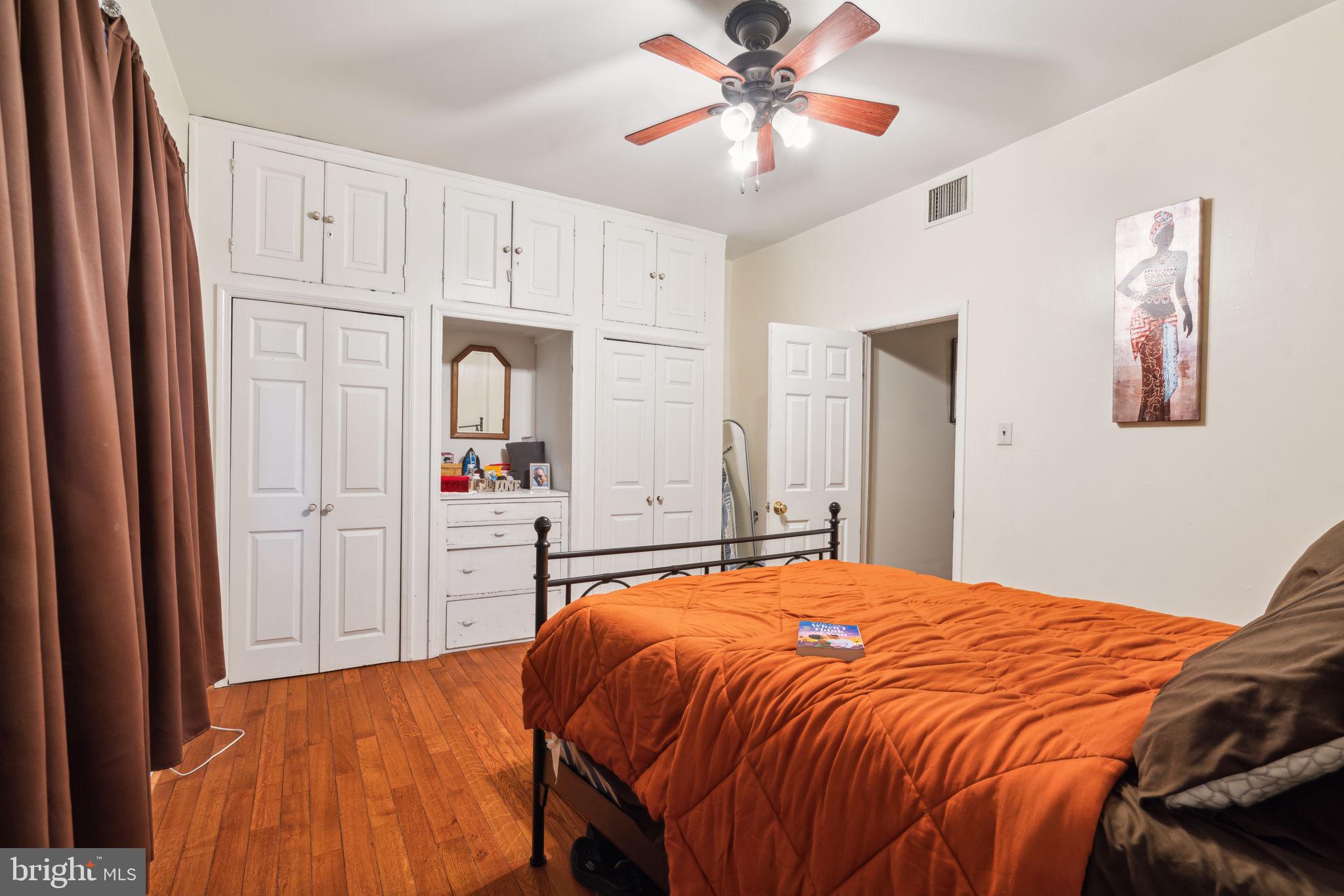 4036 Spring Garden Street Philadelphia, PA 19104 - Photo 41 of 46 a bedroom with a large bed and a chandelier