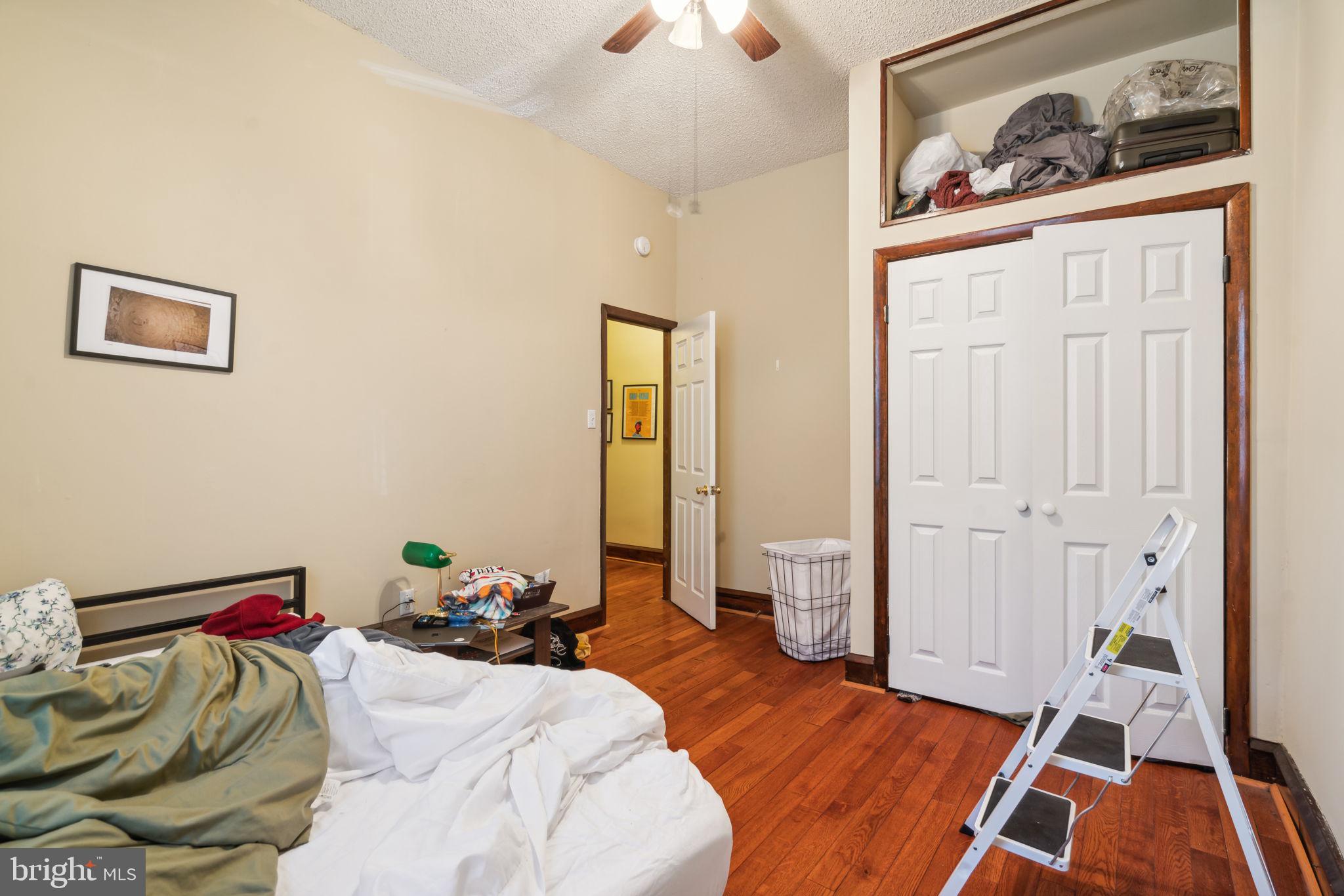 4036 Spring Garden Street Philadelphia, PA 19104 - Photo 10 of 46 a bedroom with a bed and a chandelier