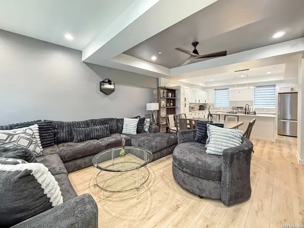 a living room with furniture and view of kitchen
