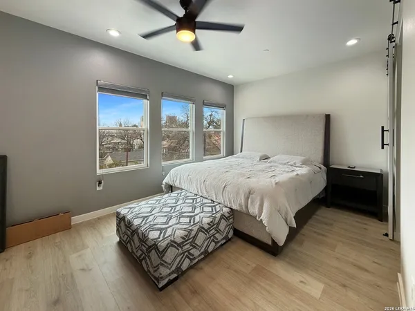 a bedroom with a bed lamp and window