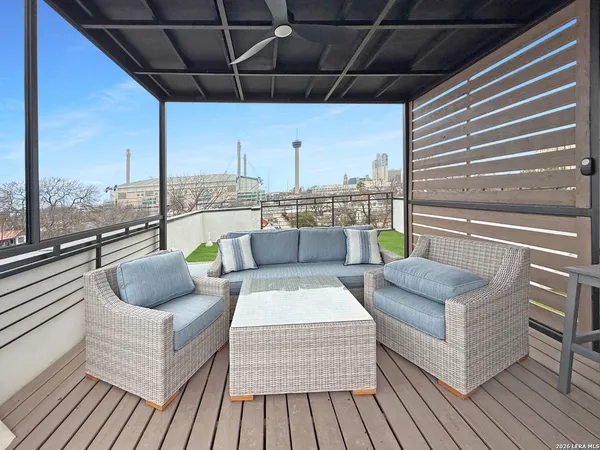 a balcony with furniture and a potted plant