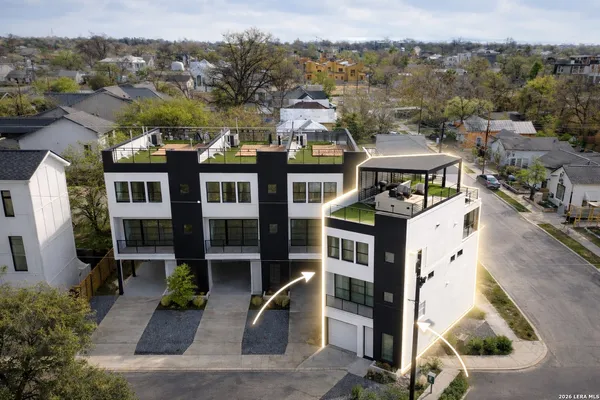 an aerial view of residential houses with outdoor space