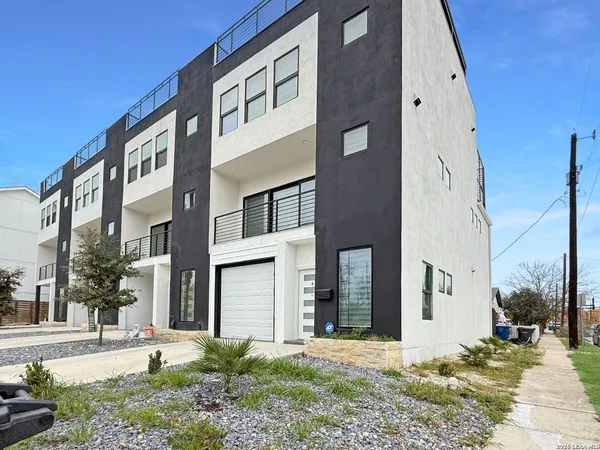 a front view of a building with a yard