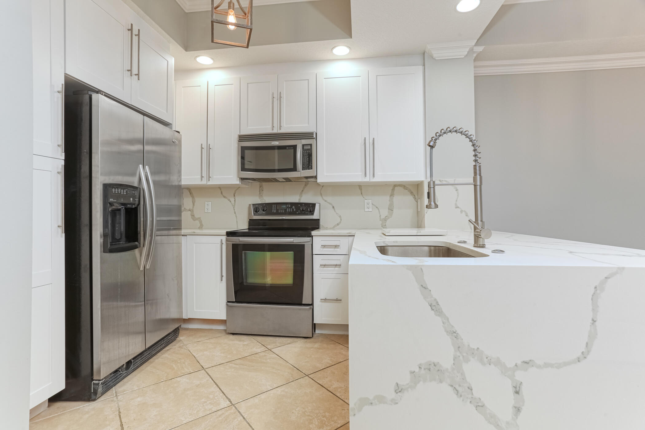 a kitchen with stainless steel appliances a stove sink and refrigerator