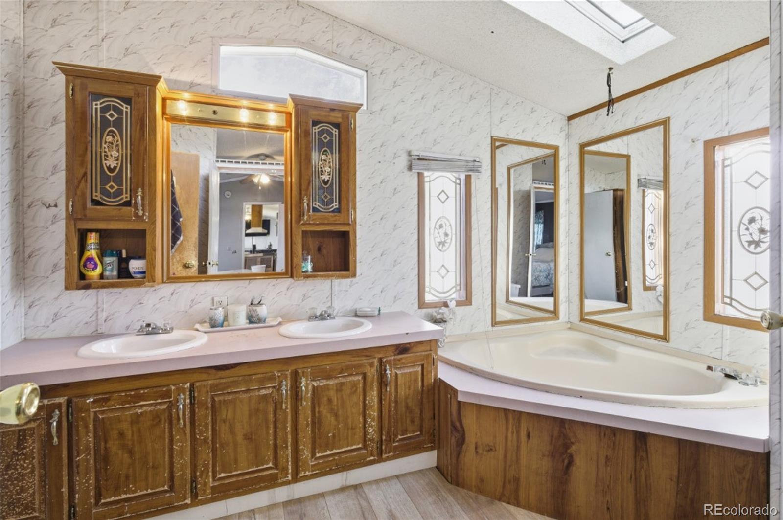 11990 East South Boulder Road Lafayette, CO 80026 - Photo 11 of 20 a bathroom with a sink and a mirror