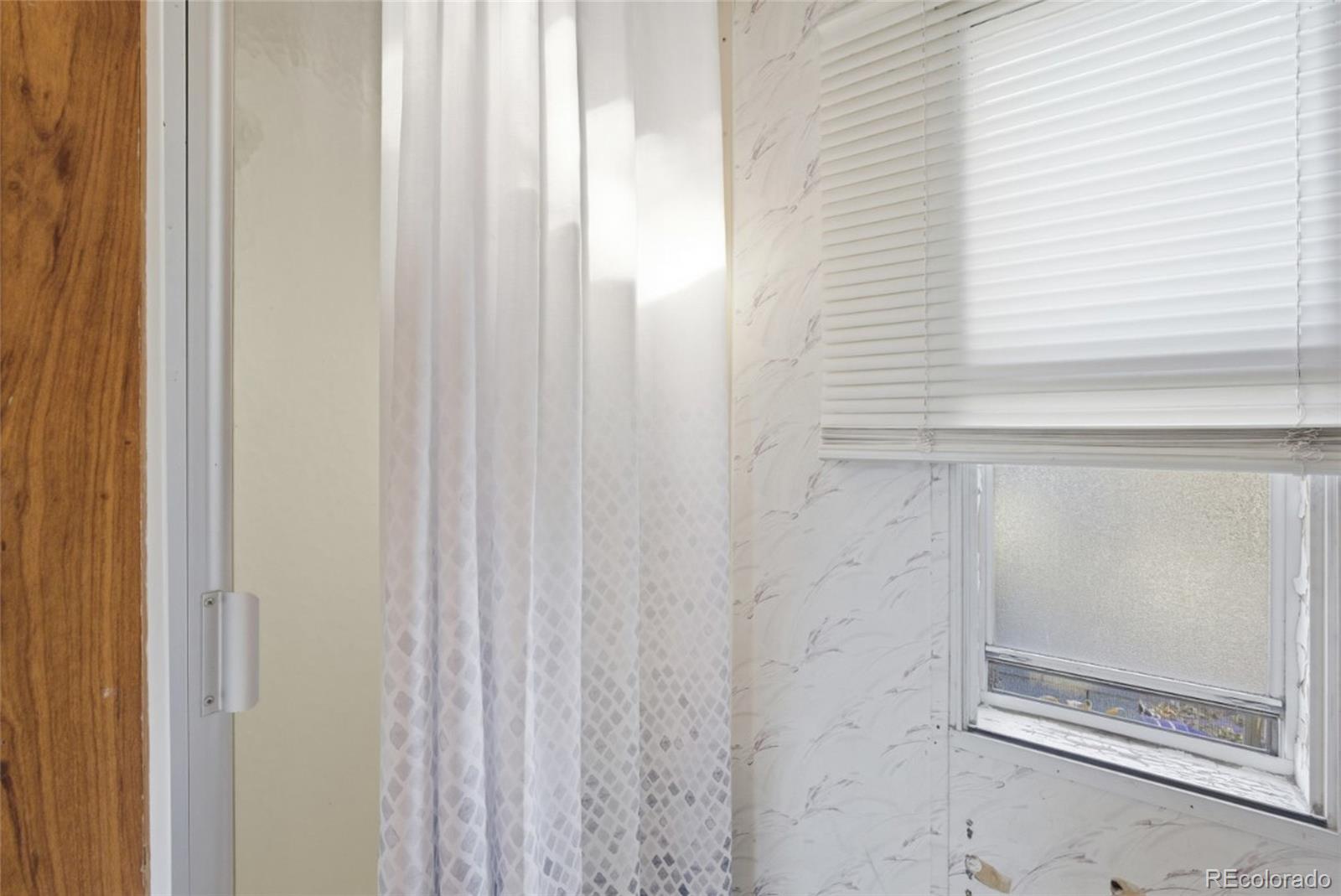 11990 East South Boulder Road Lafayette, CO 80026 - Photo 12 of 20 a bathroom with a glass shower door