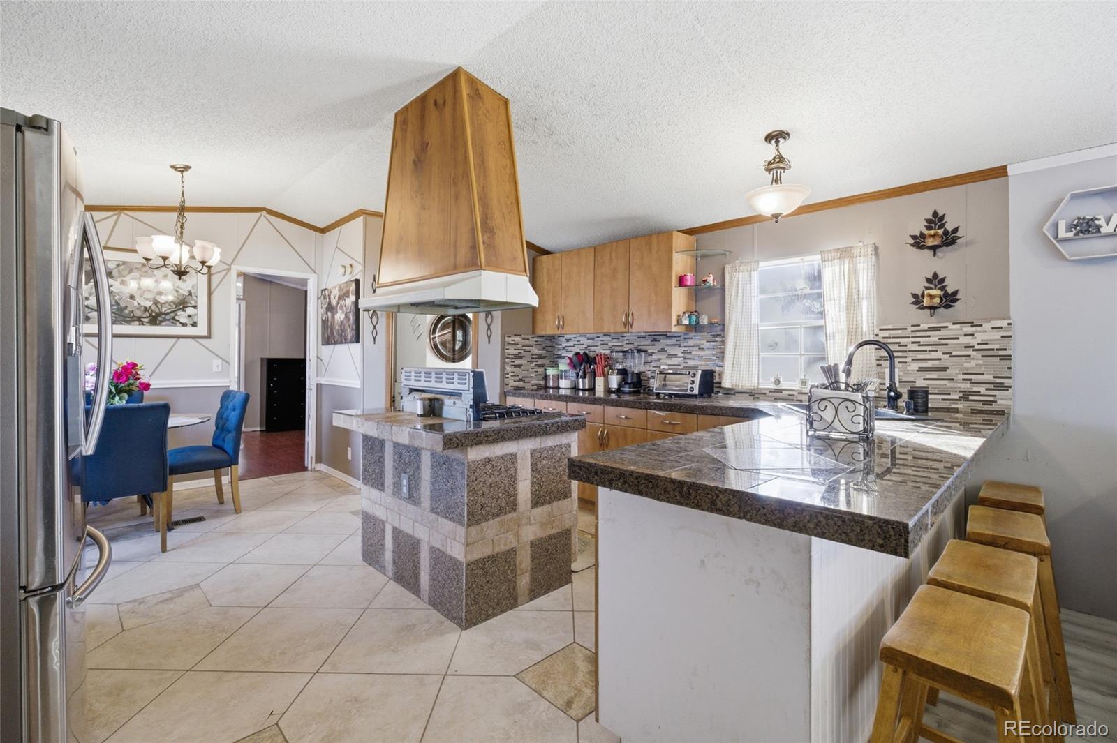 11990 East South Boulder Road Lafayette, CO 80026 - Photo 6 of 20 a kitchen with stainless steel appliances granite countertop a stove and a sink