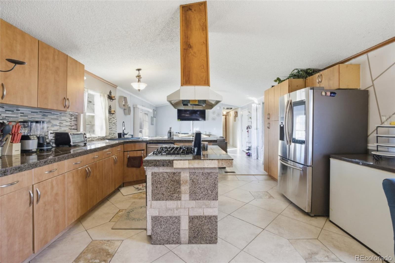 11990 East South Boulder Road Lafayette, CO 80026 - Photo 8 of 20 a kitchen with stainless steel appliances granite countertop a stove a sink and a refrigerator