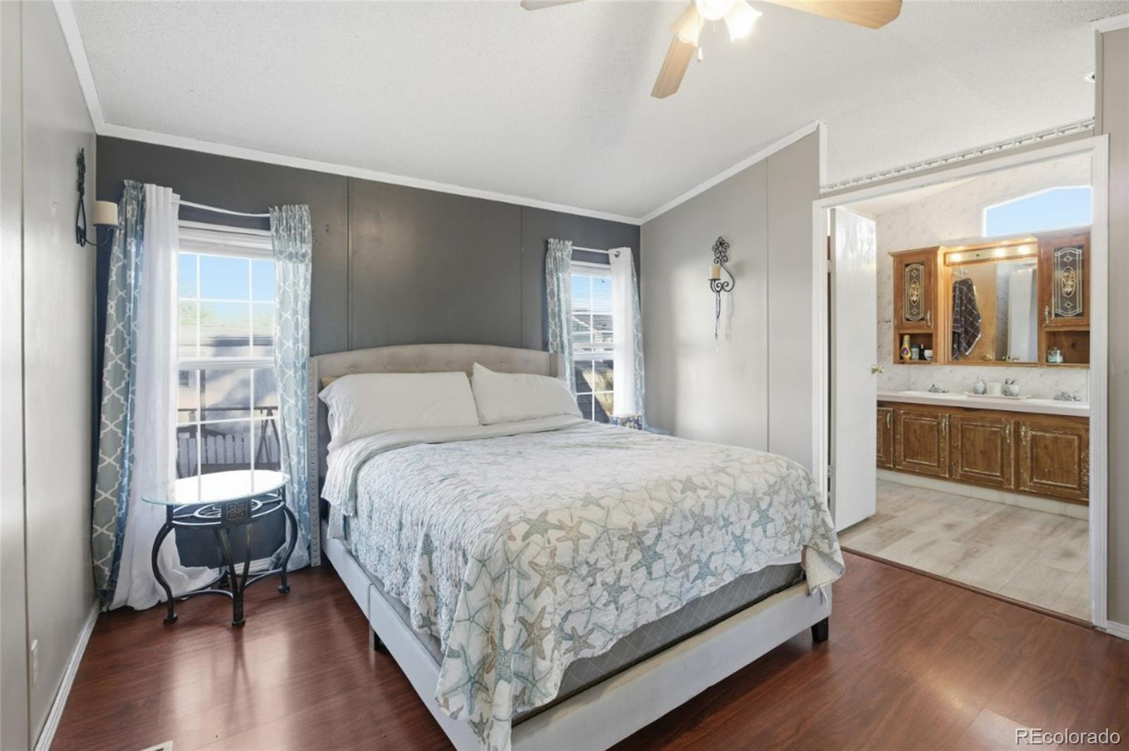 11990 East South Boulder Road Lafayette, CO 80026 - Photo 10 of 20 a bedroom with a bed and a view of en suite bathroom