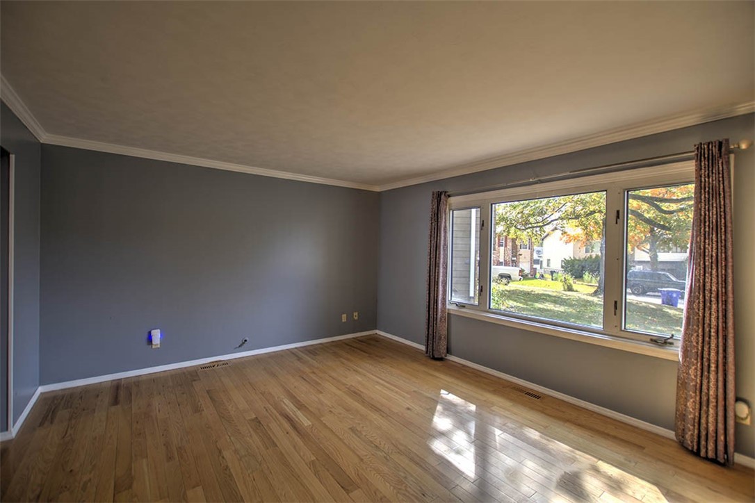 122 Bretton Court Decatur, IL 62521 - Photo 4 of 33 an empty room with wooden floor and windows