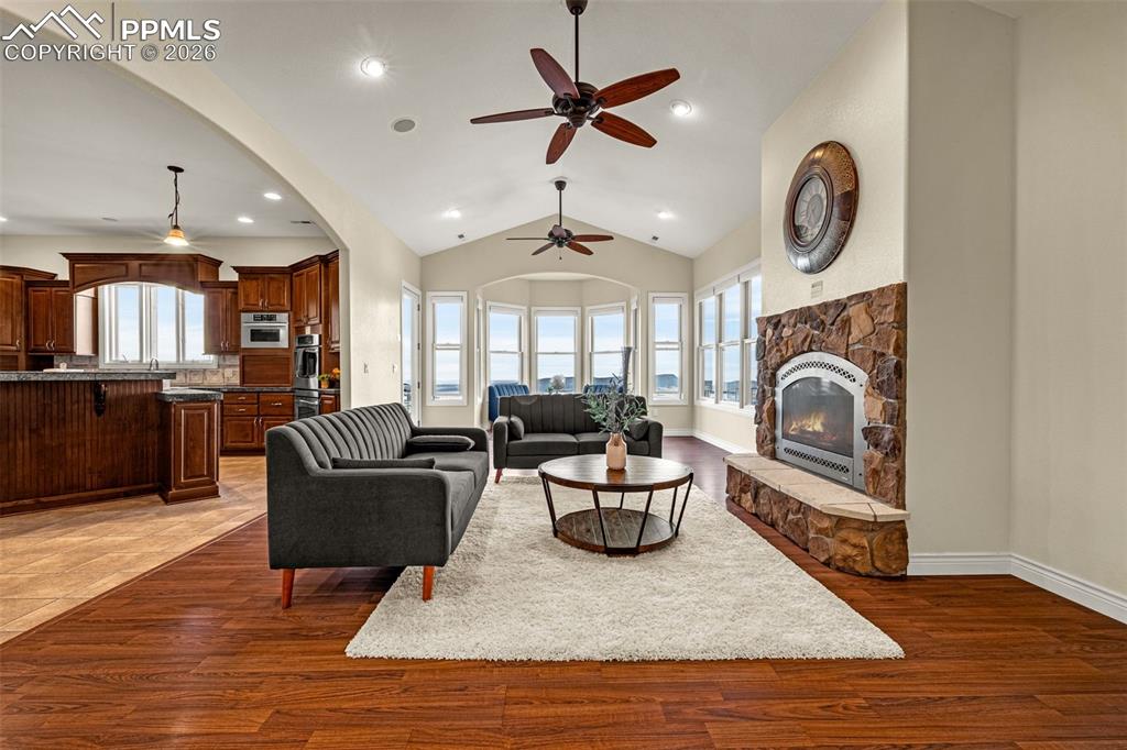 15575 Henry Ride Heights Colorado Springs, CO 80926 - Photo 14 of 46 a living room with furniture a rug and a fireplace