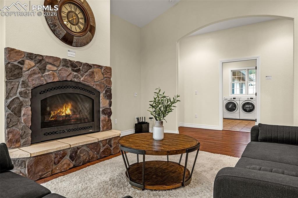 15575 Henry Ride Heights Colorado Springs, CO 80926 - Photo 20 of 46 a living room with furniture a clock and a fireplace