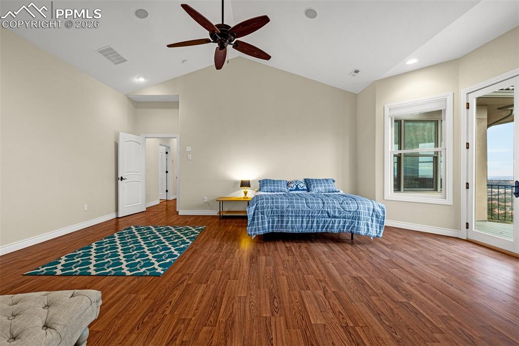 15575 Henry Ride Heights Colorado Springs, CO 80926 - Photo 24 of 46 a living room with a bed and wooden floor