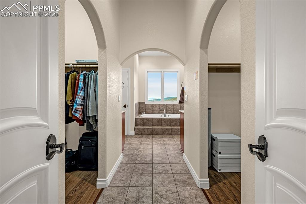 15575 Henry Ride Heights Colorado Springs, CO 80926 - Photo 25 of 46 a view of a hallway with wooden floor and entryway