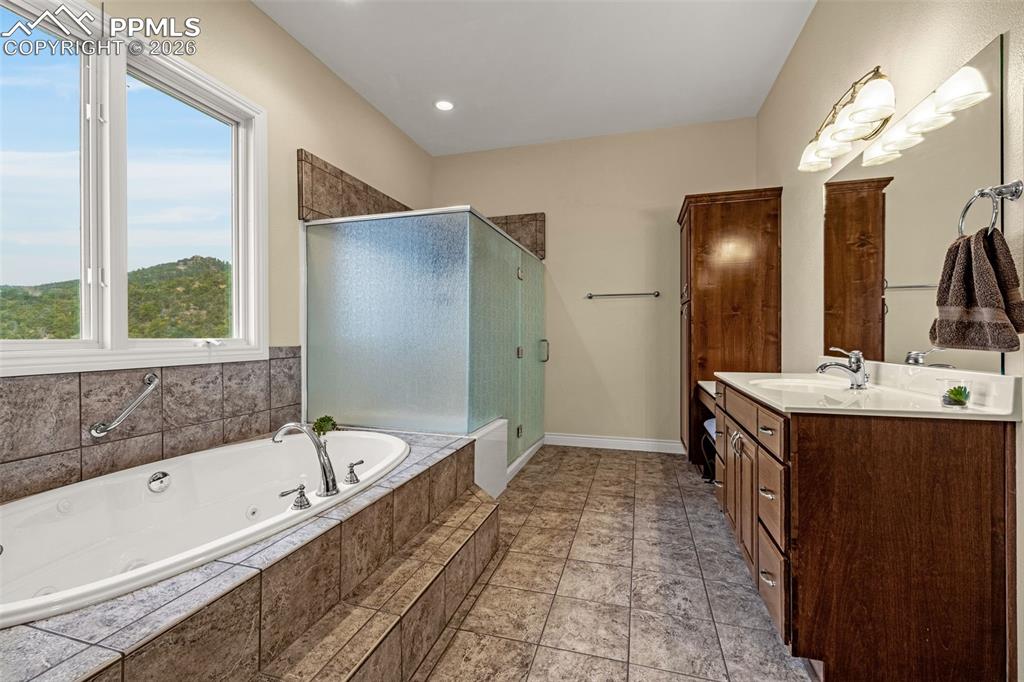 15575 Henry Ride Heights Colorado Springs, CO 80926 - Photo 26 of 46 a bathroom with a bathtub sink and mirror