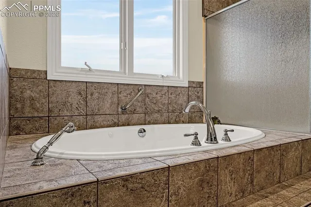 a bathroom with a tub and a sink