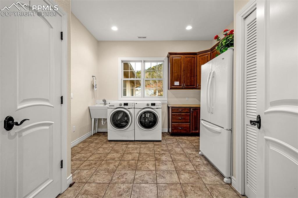 15575 Henry Ride Heights Colorado Springs, CO 80926 - Photo 30 of 46 a utility room with fridge dryer and washer