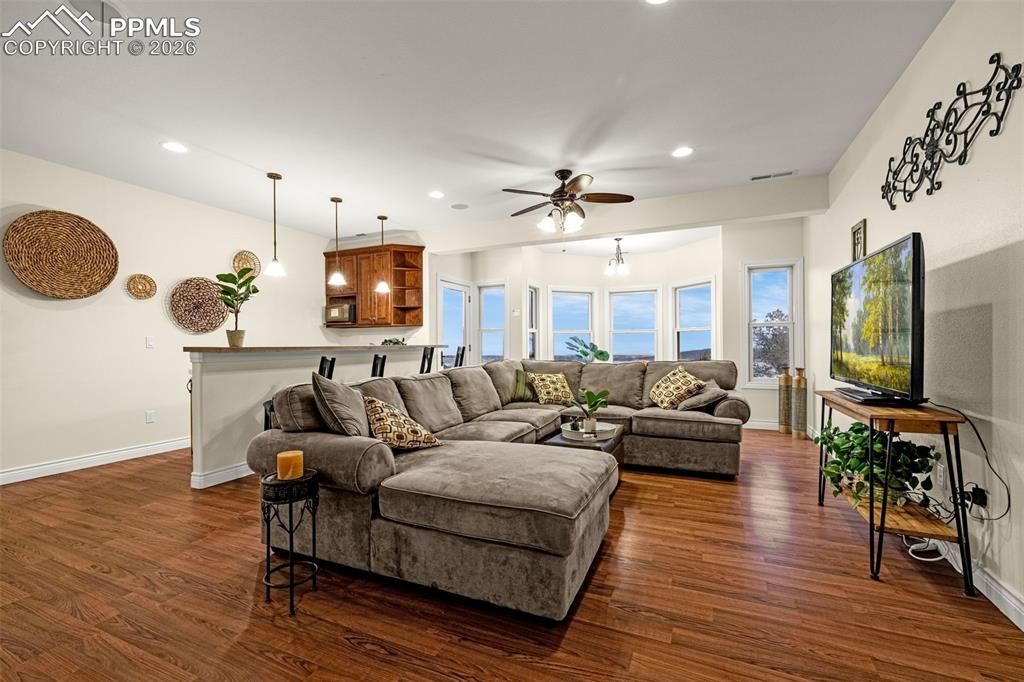 15575 Henry Ride Heights Colorado Springs, CO 80926 - Photo 31 of 46 a living room with furniture and a flat screen tv