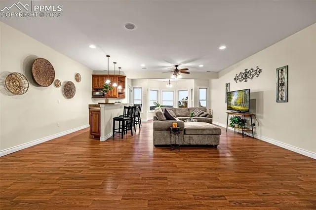 a living room with furniture and a wooden floor