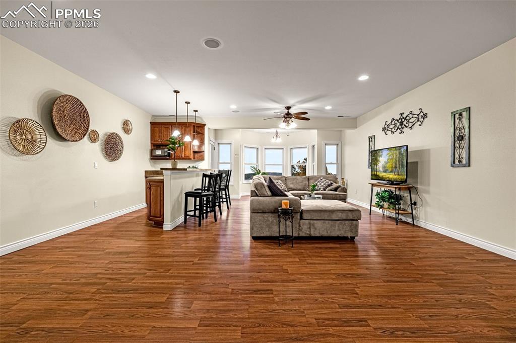 15575 Henry Ride Heights Colorado Springs, CO 80926 - Photo 33 of 46 a living room with furniture and a wooden floor