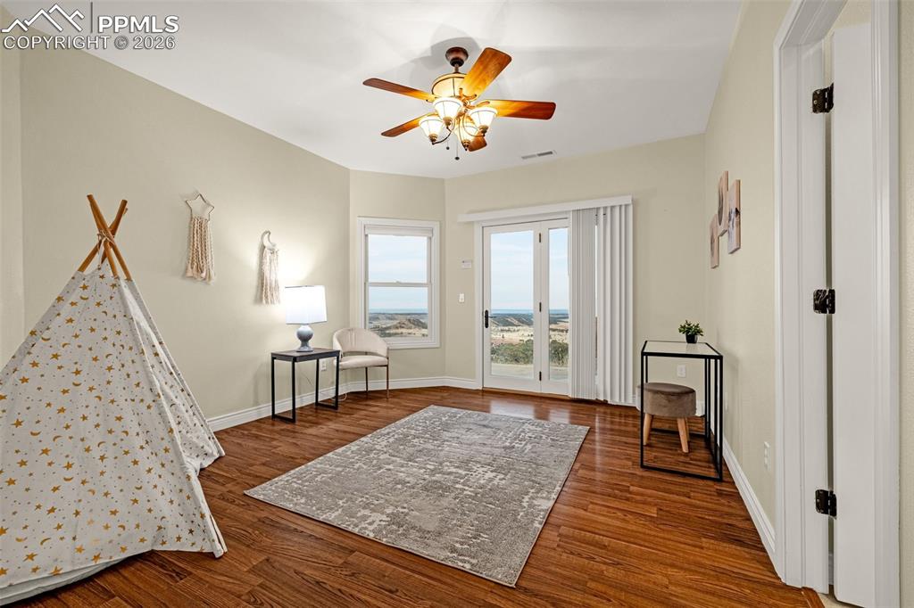 15575 Henry Ride Heights Colorado Springs, CO 80926 - Photo 35 of 46 a living room with furniture and a wooden floor