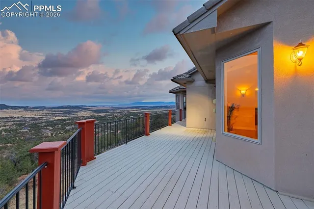 a view of a balcony with wooden floor and city view