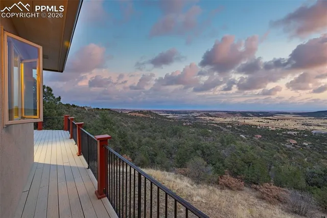 a view of a balcony with wooden fence