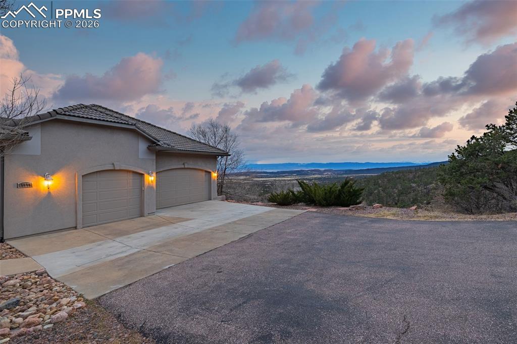 15575 Henry Ride Heights Colorado Springs, CO 80926 - Photo 45 of 46 a yellow house with yard in front of it