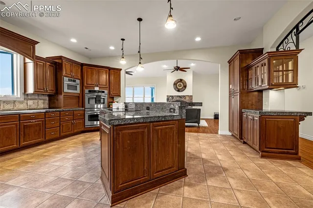 a large kitchen with a large counter top appliances and cabinets