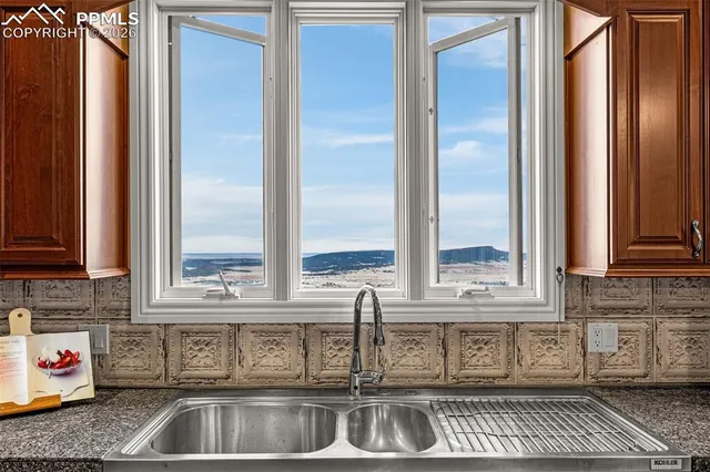 a kitchen with stainless steel appliances granite countertop a sink and a window