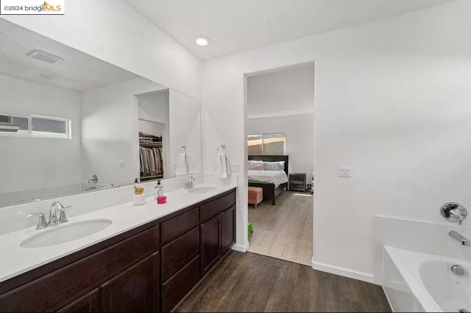 1749 Botticelli Way Lodi, CA 95242 - Photo 11 of 24 a en suite bathroom with a double vanity sink a mirror and tub