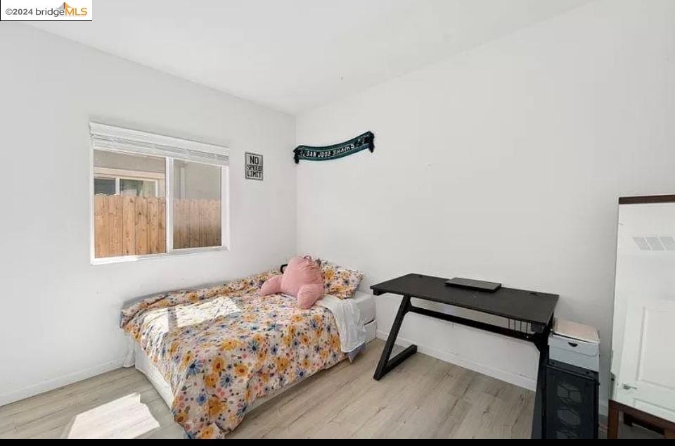 1749 Botticelli Way Lodi, CA 95242 - Photo 14 of 24 a bedroom with a bed and a window